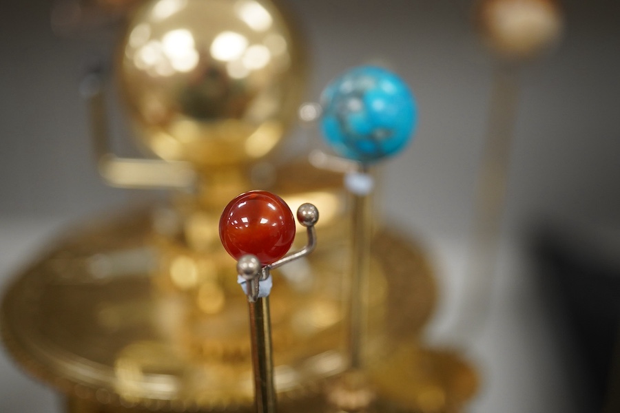 A precision brass orrery, a kit built electric operated astronomical orrery issued by Eaglemoss Publications as a part work ‘Build a Model Solar System’, complete with hardstone planets, brass moons, and a complete run o